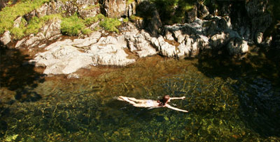 a woman swimming in a lake